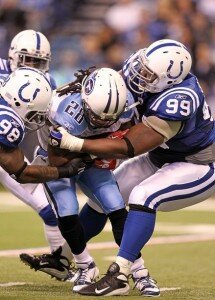 Antonio "Mookie" Johnson tackles Titans running back Chris Johnson. (Andy Lyons | Getty Images)